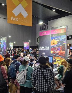 Gamers playing at Desert Beagle's Crush Zone: Demolition Derby booth at PAX Australia 2023
